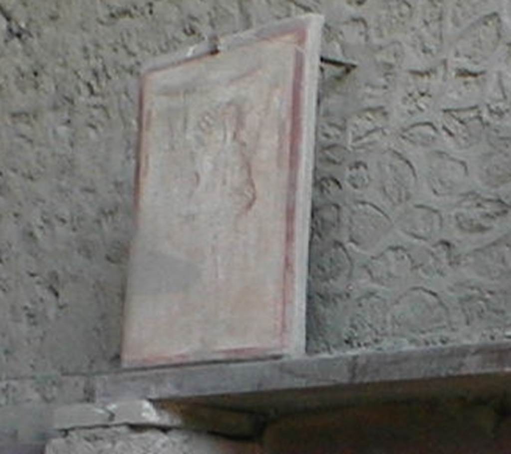 II.1.12 Pompeii. May 2005. 
Pilaster painting from south side of entrance façade, painting of Bacchus and Mercury. Currently (May 2005) in III.3.6. 
See Fröhlich, T., 1991, Lararien und Fassadenbilder in den Vesuvstädten. Mainz: von Zabern. (F16:p.312, T. 54/1).
Following the collapse of III.3.6 in November 2010, this may have been destroyed.