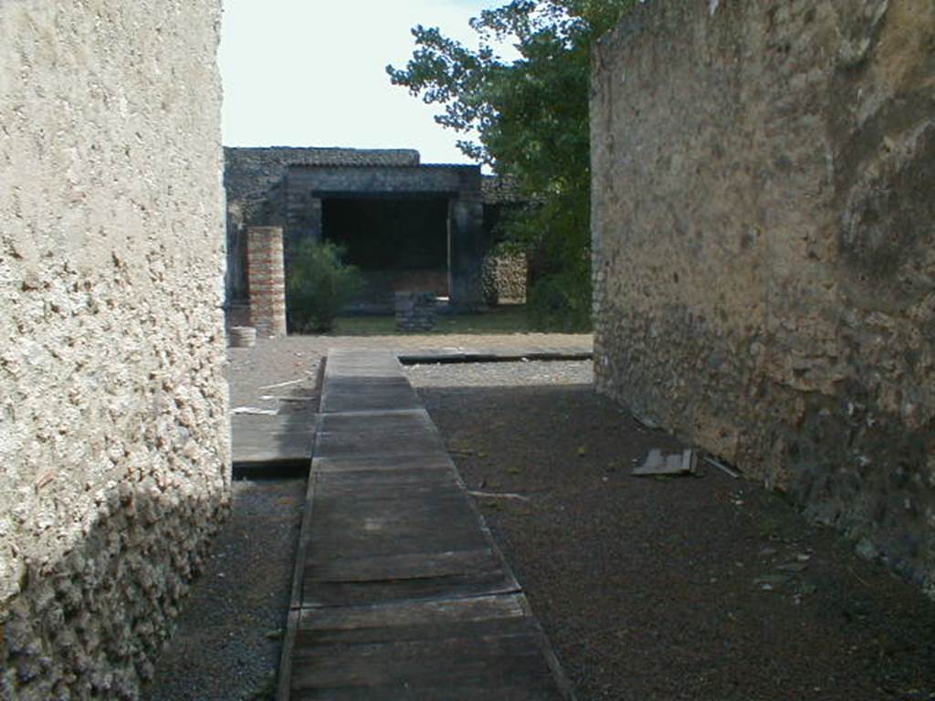 II.1.12 Pompeii. September 2004. Looking east along fauces to an area, originally the atrium that had lost its function. This area would then have led into the peristyle area, with altar and sacellum, at the rear. See, Pace, R: (1997). Il “Complesso dei Riti Magici” a Pompei II.1,11-12.  In Rivista di Studi Pompeiani, VIII, 1997, Rome, “L’Erma” di Bretschneider, (p.73-97)