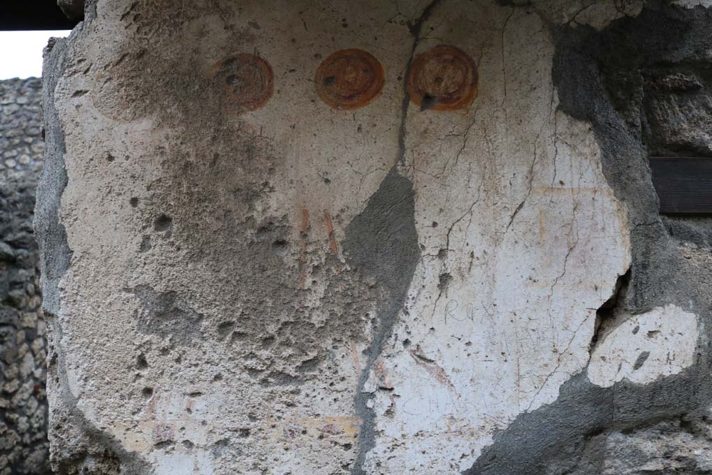 II.1.13 Pompeii. December 2018. 
Detail from painted plaster on exterior wall, on north side (left) of entrance. Photo courtesy of Aude Durand.