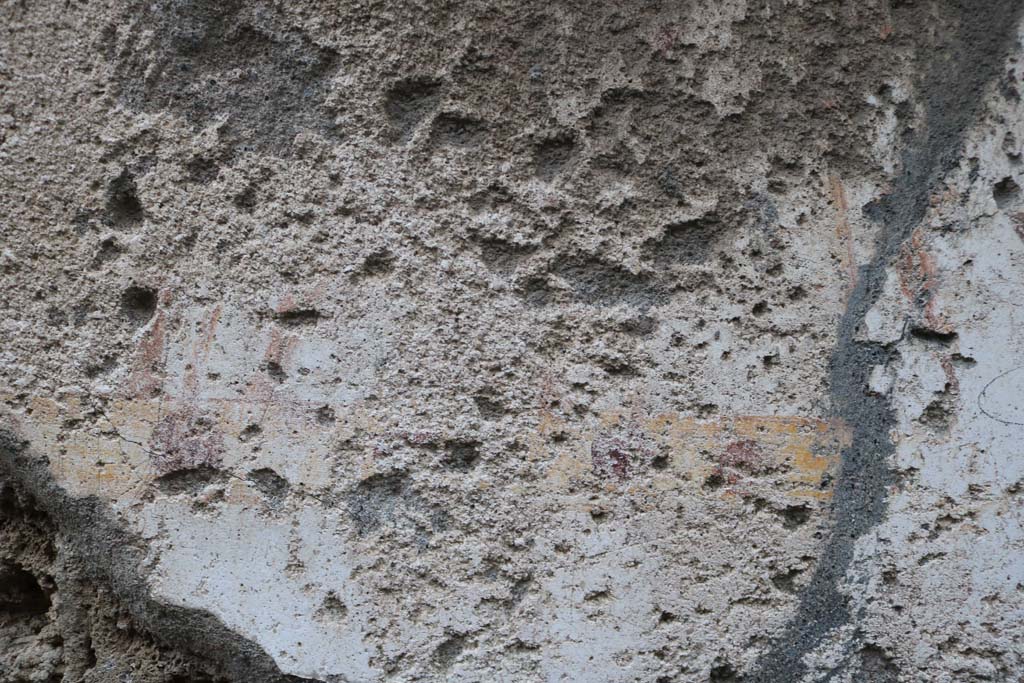 II.1.13 Pompeii. December 2018. 
Detail from painted plaster on exterior wall, on north side (left) of entrance. Photo courtesy of Aude Durand.
