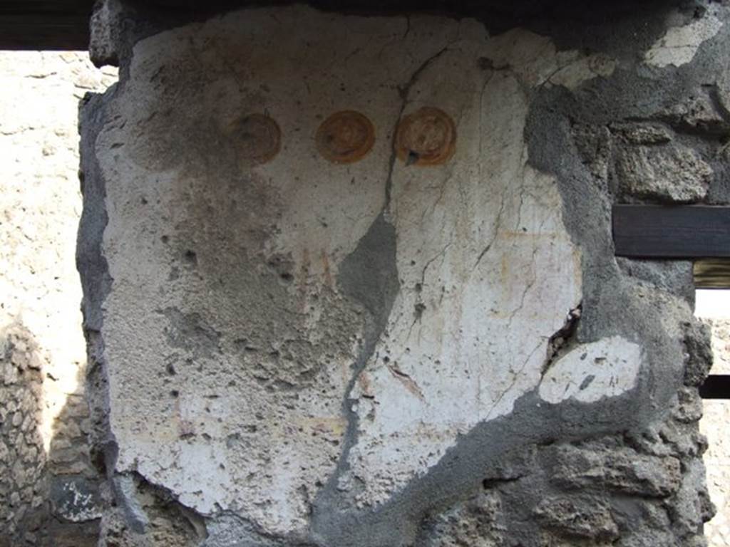 II.1.13 Pompeii. December 2007. Detail of painted plaster on exterior wall.
Inn sign?  Two men with stick or cudgel, and three hanging shields.
See Bragantini, de Vos, Badoni, 1981. Pitture e Pavimenti di Pompei, Parte 1. Rome: ICCD. (p.212).  See Fröhlich, T., 1991. Lararien und Fassadenbilder in den Vesuvstädten. Mainz: von Zabern. (F15)