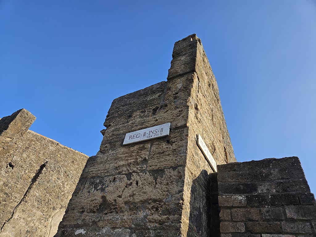 II.2.1 Pompeii. November 2024. Insula identification plaque describing it originally as Reg. II, Insula V. Photo courtesy of Annette Haug.