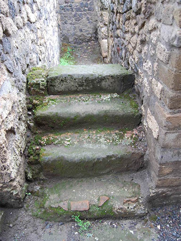 II.2.1 Pompeii. May 2014. Looking west at stairs at rear of bar-room, in south-east corner.
The doorway on the left of the picture would have led into the atrium of II.2.2. Photo courtesy of Paula Lock.