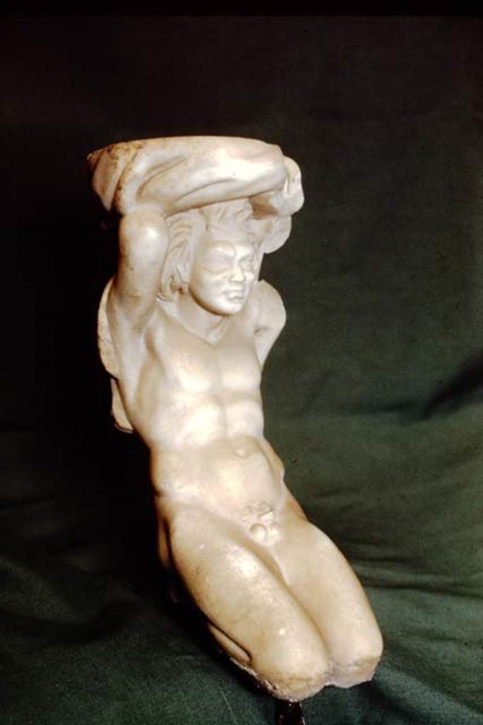II.2.2 Pompeii. 1978. 
Room “k”, marble kneeling Telamon in the form of a kneeling satyr. SAP inventory number 2891.
According to Wilhelmina, this was found on the terrace, but according to Spinazzola, possibly stood in the aedicula, and that water may have splashed from the basin which the statuette supported on its shoulders. However, Dr. Salza Prina Ricotti pointed out that, at least today, there is no evidence of pipes to justify it as a fountain.
Source: The Wilhelmina and Stanley A. Jashemski archive in the University of Maryland Library, Special Collections (See collection page) and made available under the Creative Commons Attribution-Non Commercial License v.4. See Licence and use details.
J78f0158
See Jashemski, W. F., 1993. The Gardens of Pompeii, Volume II: Appendices. New York: Caratzas, (p.78-80).
