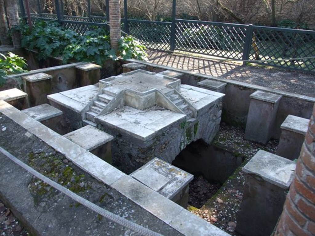 II.2.2 Pompeii. March 2009. Room “l”, garden. Pool and fountain shaded by pergola. 
Looking south-west from north end. The fountain has four sets of marble steps on a central platform. 
Around the edge are twelve statue or fountain ornament bases.