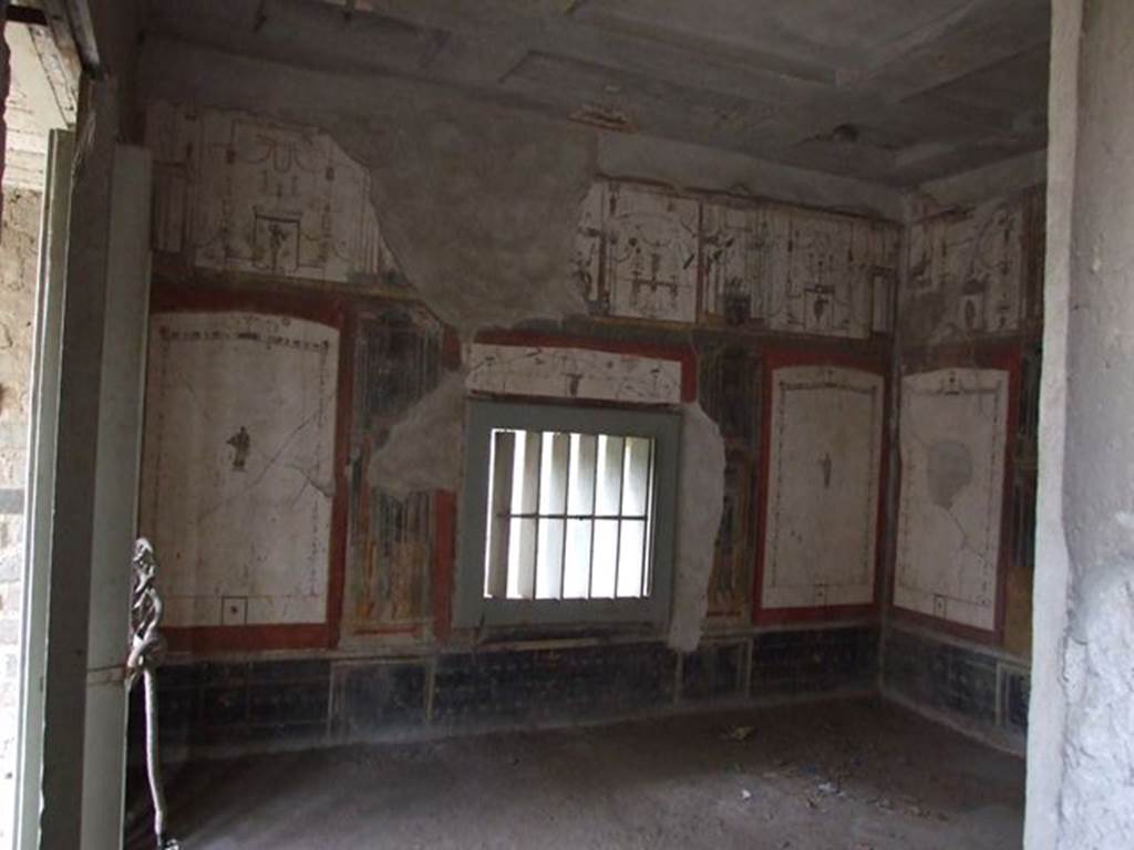 II.2.2 Pompeii. December 2006. Room “f”, Oecus of west side of pseudoperistyle, looking south. 
According to Garcia y Garcia, this room also suffered due to the bombing of 19th September 1943.
Partly damaged was the south wall of the white oecus in IV Style.
The other walls also suffered from the fall and partial loss of the painted stucco, which was largely saved and restored from numerous small fragments.
See Garcia y Garcia, L., 2006. Danni di guerra a Pompei. Rome: L’Erma di Bretschneider. (p.45-47).
Kuivalainen describes the upper central figure as partially destroyed, and comments –
“Young sitting Bacchus, on account of the pose and the thyrsus. The decoration clearly indicates cultic purposes.”
See Kuivalainen, I., 2021. The Portrayal of Pompeian Bacchus. Commentationes Humanarum Litterarum 140. Helsinki: Finnish Society of Sciences and Letters, (p.102, B15).