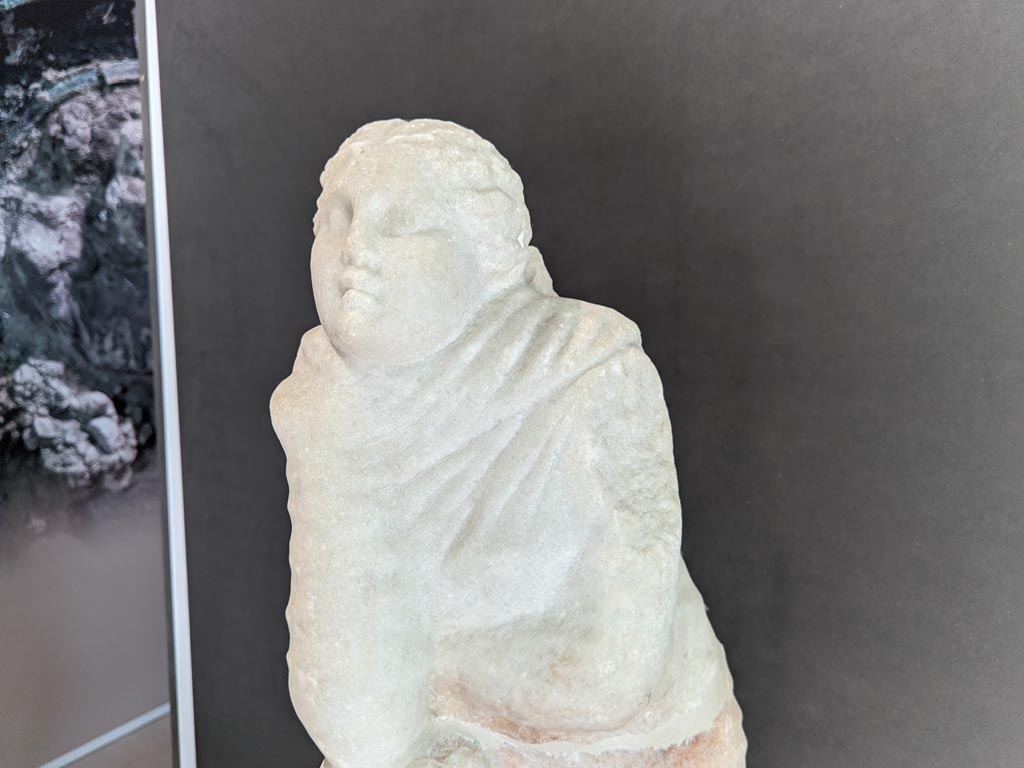 II.2.2 Pompeii. April 2022. 
Detail of marble statue of the muse Polyhymnia, on display in exhibition in Palaestra. Photo courtesy of Giuseppe Ciaramella.