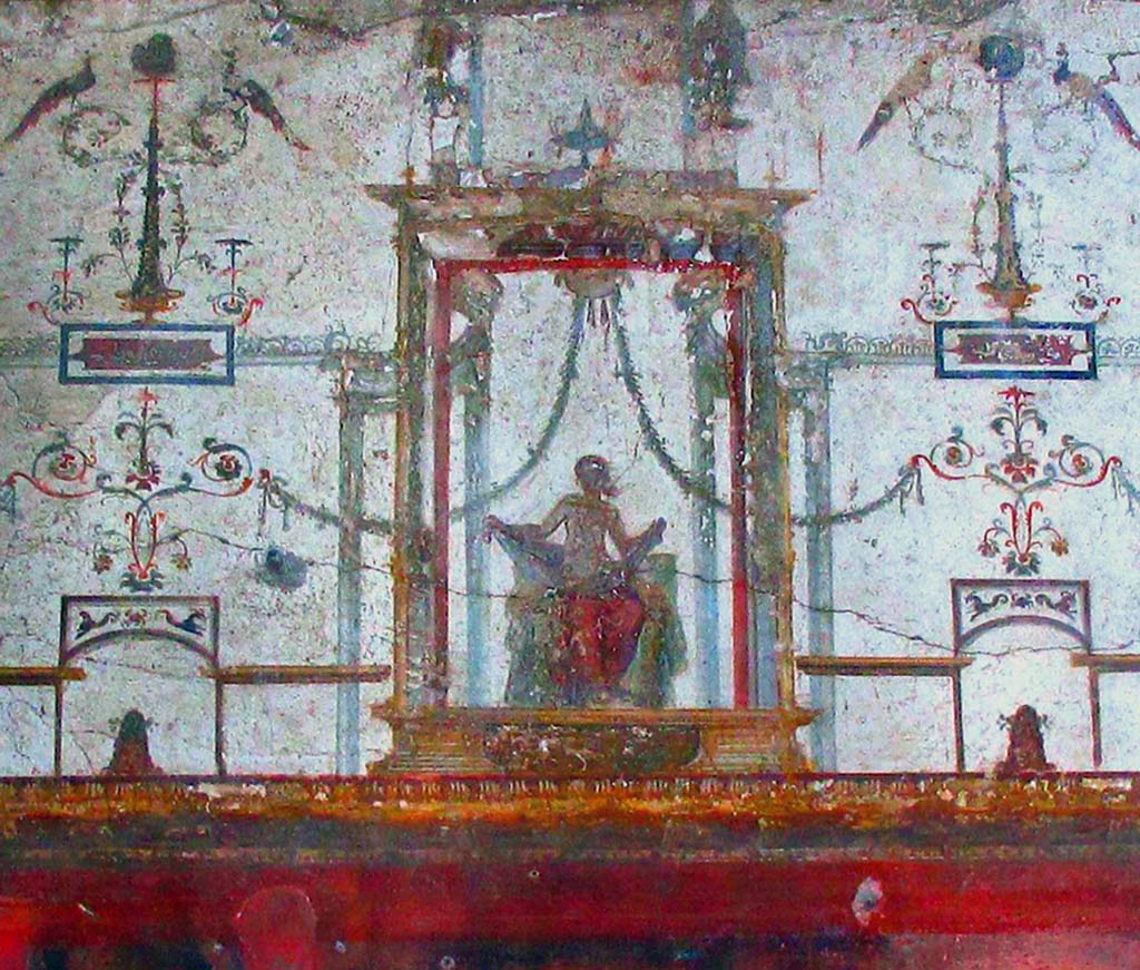 II.2.2 Pompeii. April 2016. 
Room “f”, detail of upper centre of west wall with fresco in Fourth style of seated figure. Photo courtesy of Davide Peluso.