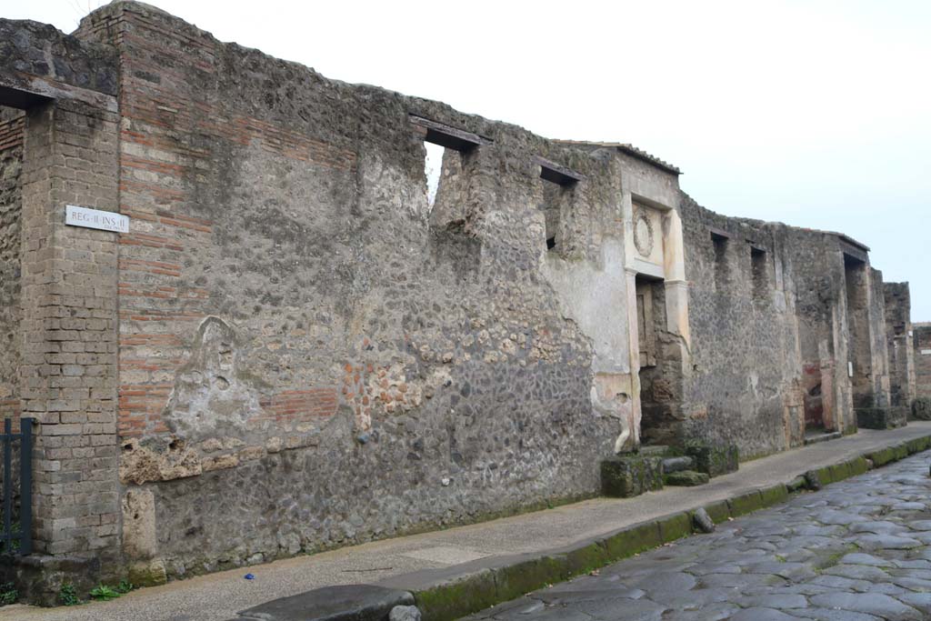 II.2.4 Pompeii. December 2018. 
Looking west on south side of Via dell’Abbondanza towards II.2.4 through to II.2.1. Photo courtesy of Aude Durand.