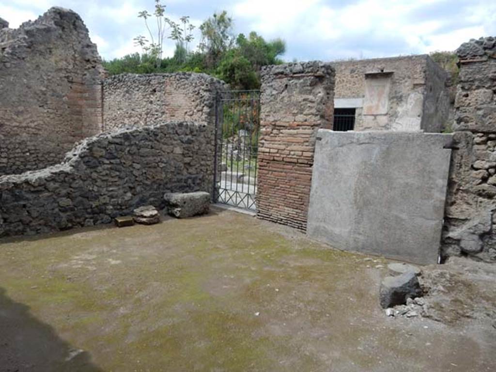 II.3.2 Pompeii. May 2016.  Rear of plaster cast of doors, and II.3.1 entrance to stairs to upper floor, on north wall. Photo courtesy of Buzz Ferebee.