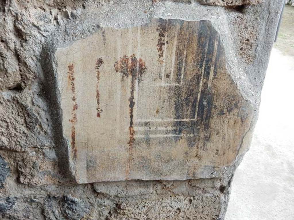 II.3.3 Pompeii. May 2016. Room 16, north wall with painted decoration near door-post.  Photo courtesy of Buzz Ferebee.