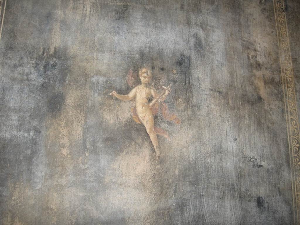 II.3.3 Pompeii. July 2007. Room 6, south wall of triclinium. 
Wall painting of Amorino or flying cupid with a baetylus (or alabaster vase) in his left hand.
Photograph courtesy of Kathryn Breen.