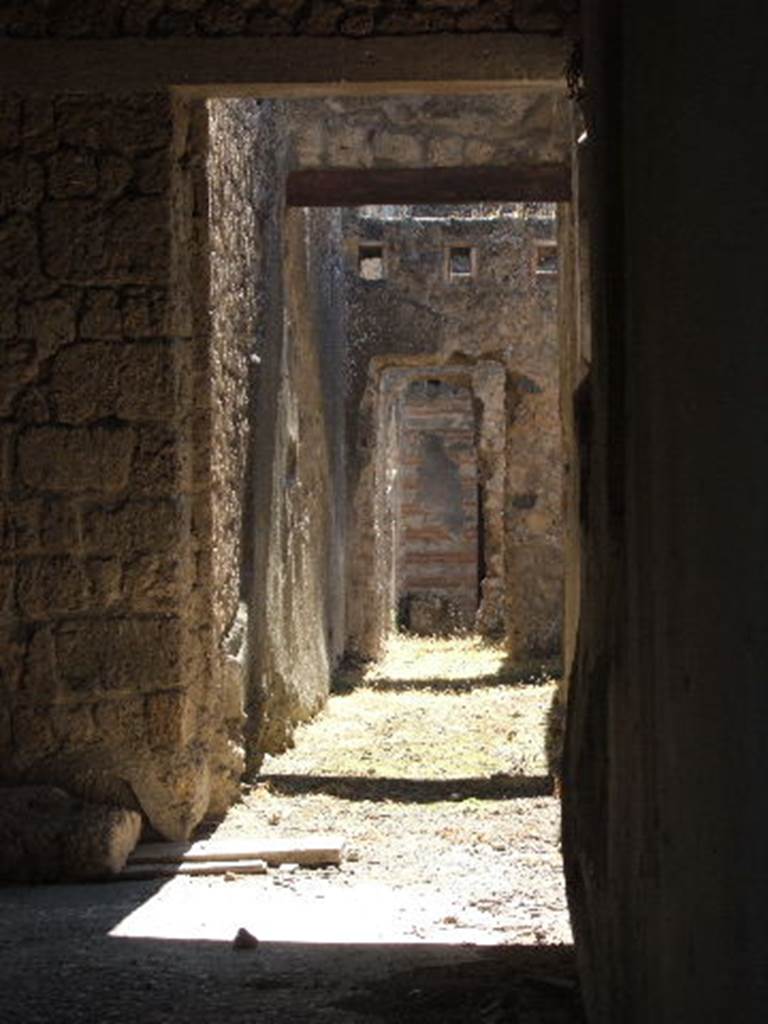 II.4.2 Pompeii. September 2005. Looking south from doorway towards passage at rear.