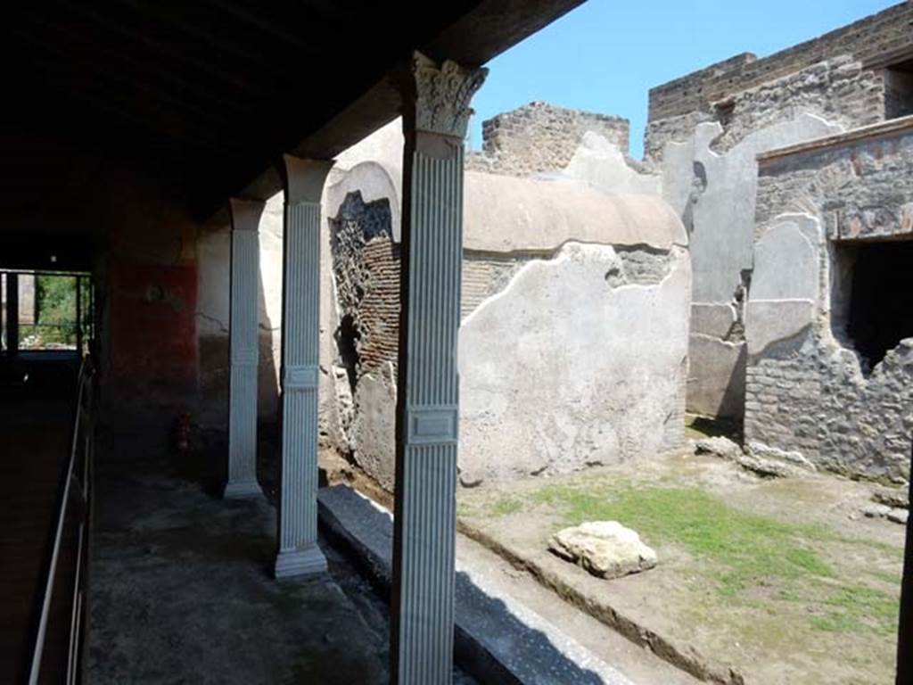 II.4.6 Pompeii. May 2016. Looking north along west portico towards doorway to II.4.2/3, on left. Photo courtesy of Buzz Ferebee.