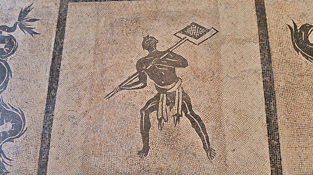 II.4.6 Pompeii. September 2017. 
Black and white mosaic from centre of floor showing a furnaceman and a marine scene set in floor of Naples Museum.
Photo courtesy of Giuseppe Ciaramella.