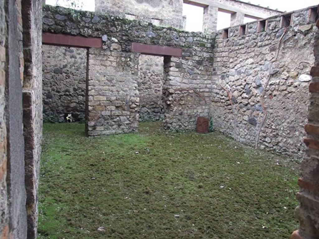 II.4.6 Pompeii. December 2006.  Looking through doorway from west portico into room with two doorways in its west wall into a corridor, at the rear.
