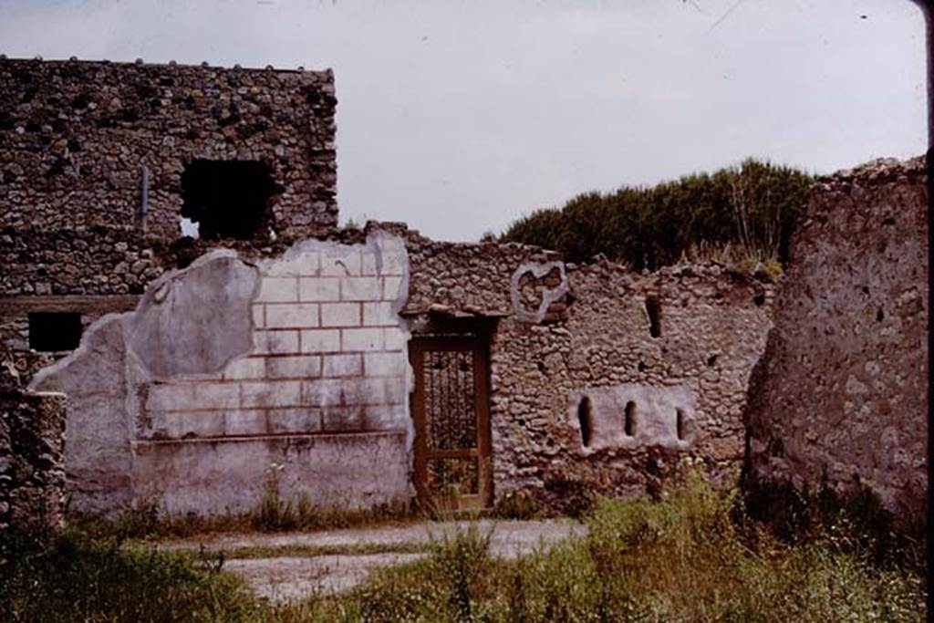 II.4.10 Pompeii. 1964. Vicolo di Giulia Felice, looking east towards entrance doorway. 
Exterior west wall (without showing any of the graffiti underneath). Photo by Stanley A. Jashemski.
Source: The Wilhelmina and Stanley A. Jashemski archive in the University of Maryland Library, Special Collections (See collection page) and made available under the Creative Commons Attribution-Non-Commercial License v.4. See Licence and use details.
J64f0971