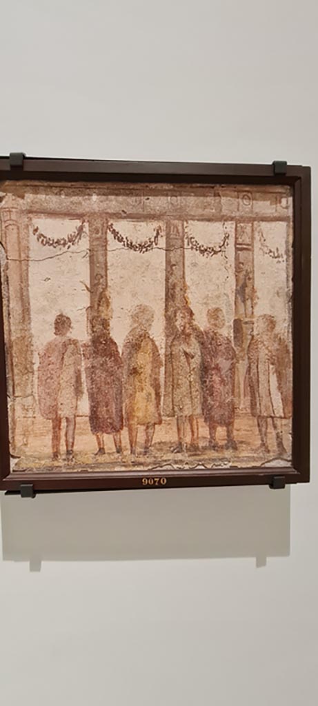 II.4.3 Pompeii. April 2023. 
Paintings of the Forum frieze, on display in “Campania Romana” gallery in Naples Archaeological Museum.
Above (inv. 9070) – Sei uomini davanti a colonnata e statue. (Six men in front of a colonnade and statues).
Photo courtesy of Giuseppe Ciaramella.