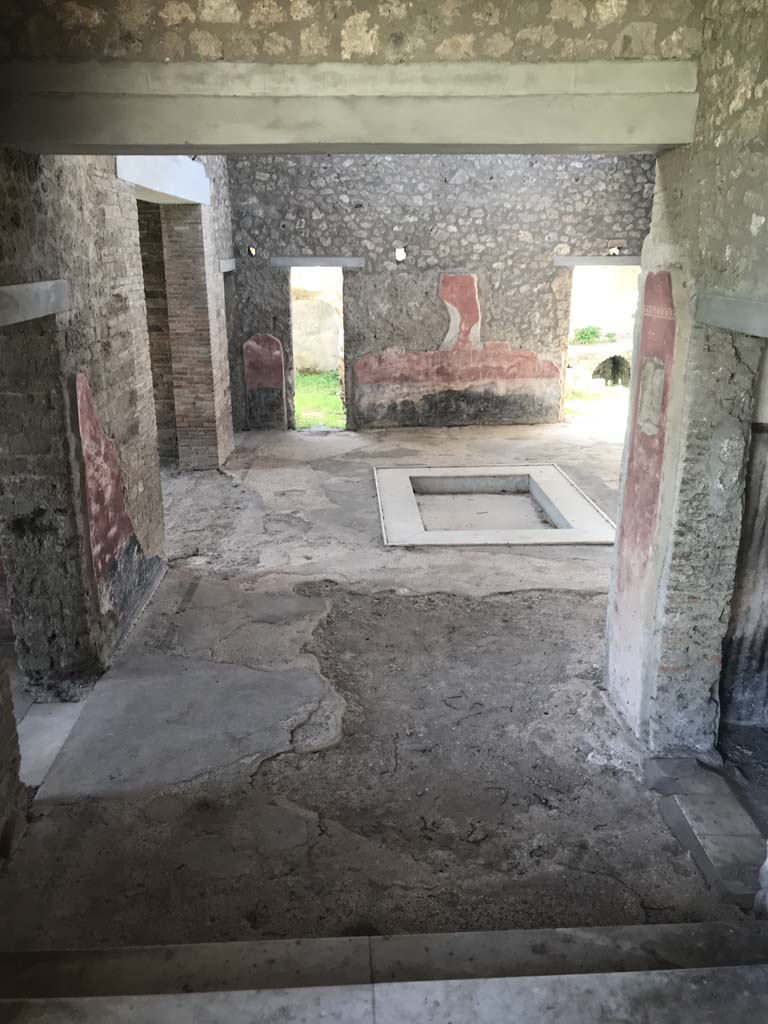 II.4.6/10 Pompeii. April 2019. 
Looking south into atrium of II.4.10, from top of steps at south end of portico of II.4.6. 
To view these rooms, see II.4.10. Photo courtesy of Rick Bauer.