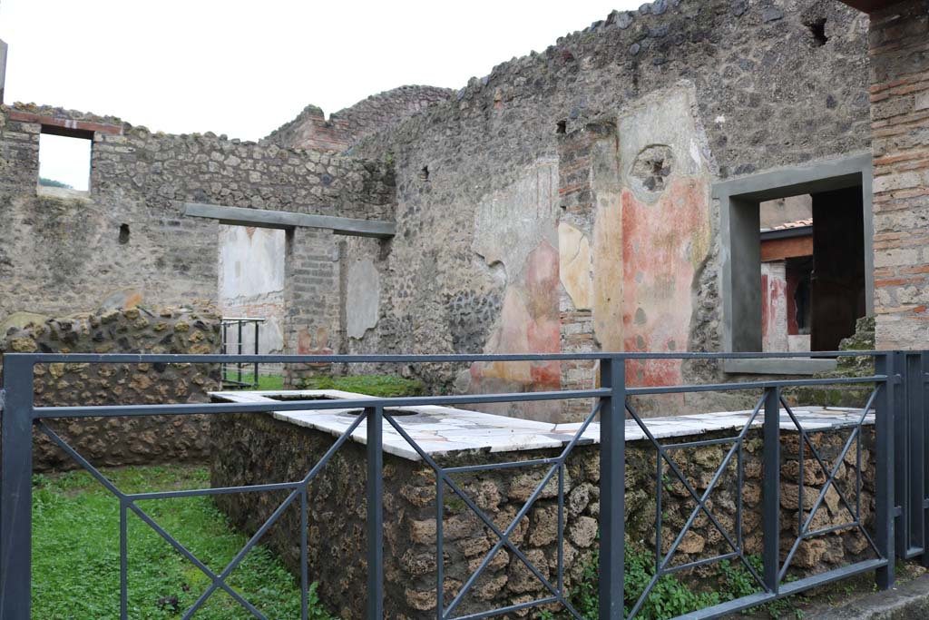 II.4.7 Pompeii. December 2018. 
Looking south-west across bar-room from entrance on Via dell’Abbondanza. Photo courtesy of Aude Durand.