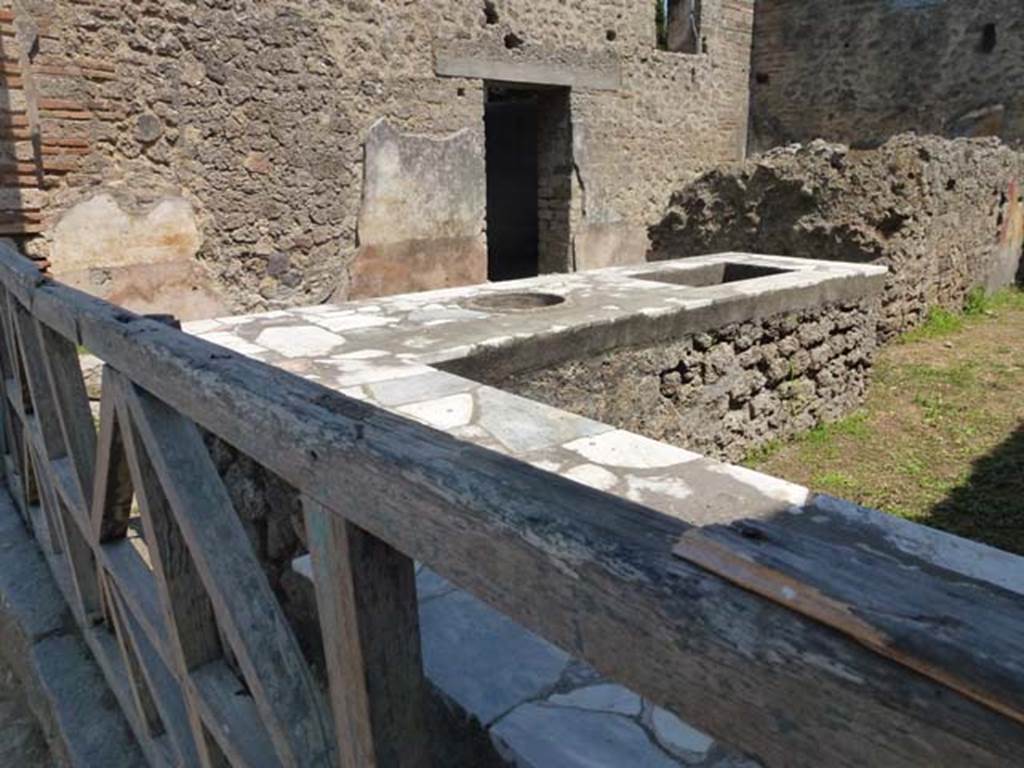 II.4.7 Pompeii. June 2012. Looking across podium towards east wall, from entrance. Photo courtesy of Michael Binns.