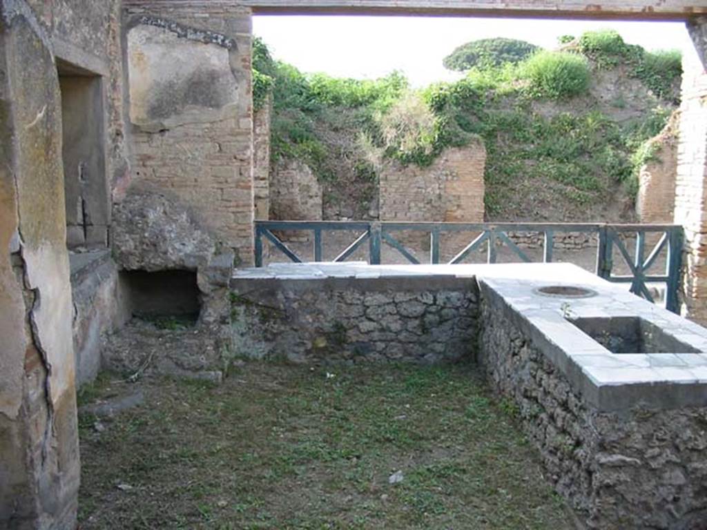 II.4.7 Pompeii. May 2003. Looking north across rear of counter towards doorway on Via dell’Abbondanza, Photo courtesy of Nicolas Monteix.