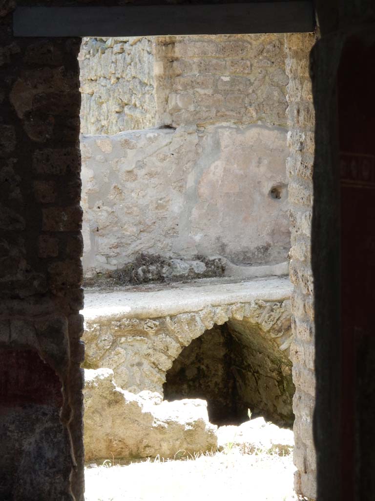 II.4.10 Pompeii. June 2019. Detail of hearth through kitchen doorway from atrium. 
Photo courtesy of Buzz Ferebee.