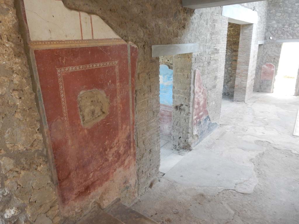 II.4.10 Pompeii. June 2019. Looking south along east wall of atrium, from steps leading from west portico. 
In the centre is the doorway to the biclinium, followed by wide doorway to the tablinum.
In the south-east corner, upper right, is a small doorway to a cubiculum which then leads into a second bedroom, followed by a doorway in the south wall. Photo courtesy of Buzz Ferebee.