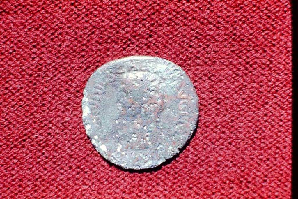 II.5 Pompeii, 1968. Detail of coin.  Photo by Stanley A. Jashemski.
Source: The Wilhelmina and Stanley A. Jashemski archive in the University of Maryland Library, Special Collections (See collection page) and made available under the Creative Commons Attribution-Non Commercial License v.4. See Licence and use details.
J68f1795