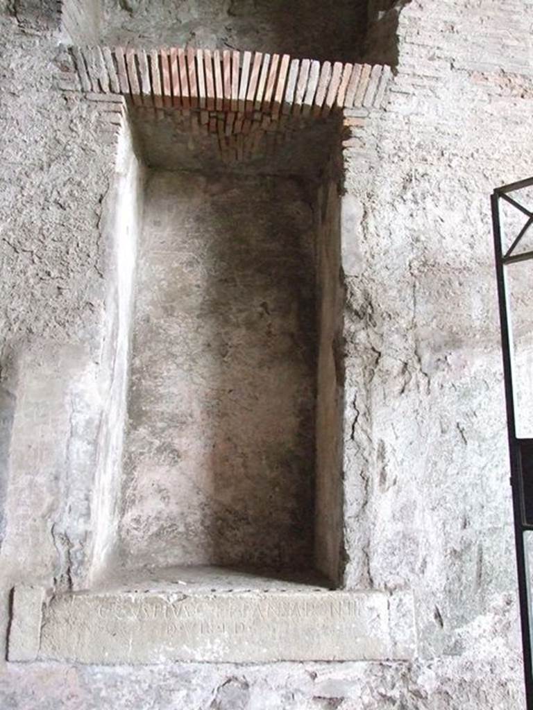 II.6 Pompeii. December 2006. Large rectangular niche, on west side of corridor in Amphitheatre.  One of two inscriptions to father and son Cuspius Pansa.  They restored the Amphitheatre at their own expense after the earthquake of AD62.