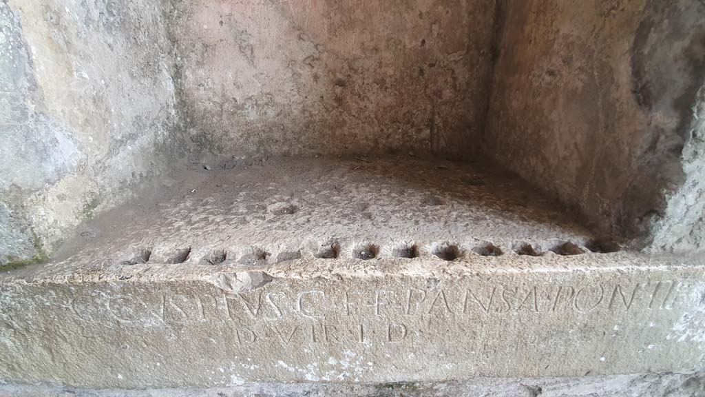 II.6 Pompeii. July 2021. Detail of shelf in niche, with inscription from west side of corridor of Amphitheatre 
Foto Annette Haug, ERC Grant 681269 DÉCOR.