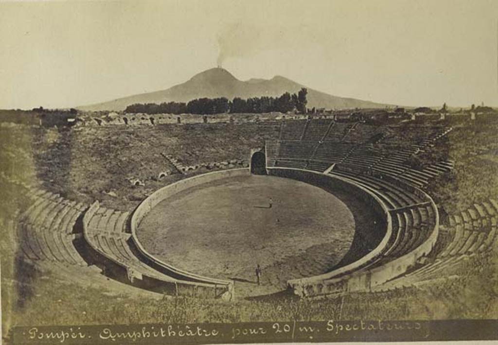 II.6 Pompeii. Old undated photograph by Mauri, no.024.  Looking north across amphitheatre to a smoking Vesuvius. Photo courtesy of Rick Bauer.