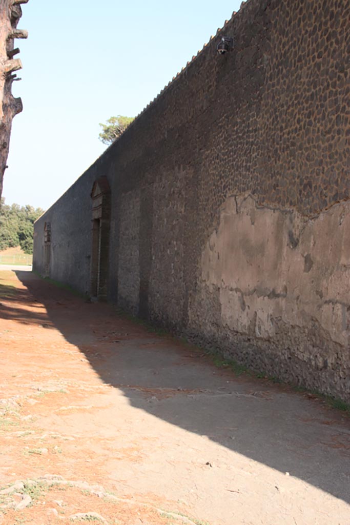 II.7.7 Pompeii. Palaestra. October 2023. 
Looking east along exterior north wall towards II.7.6 and II.7.7. Photo courtesy of Klaus Heese.