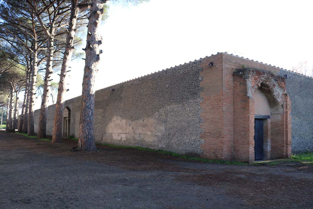 II.7.8 Pompeii. Palaestra. December 2018. 
Looking east along north side, with entrance doorway II.7.8, on right. Photo courtesy of Aude Durand