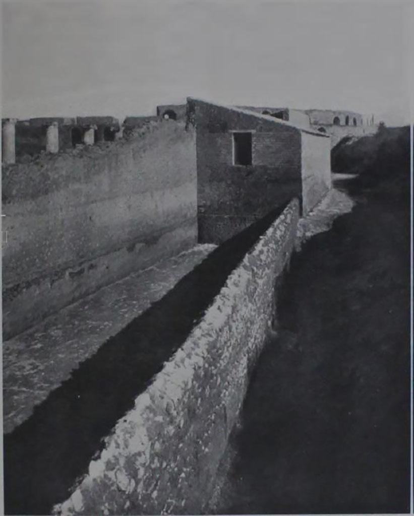 II.7.1/II.7.11 Pompeii. 1939.  “La forica della Palestra”. 
Looking east along south side of long tapered walled enclosure, towards the amphitheatre.
See Notizie degli Scavi, 1939, p. 191, fig.16.