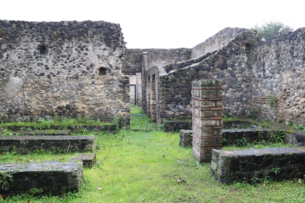 II.8.5 Pompeii. December 2018. 
Looking west towards atrium and entrance doorway, across three-sided stone benches and tables. Photo courtesy of Aude Durand.
