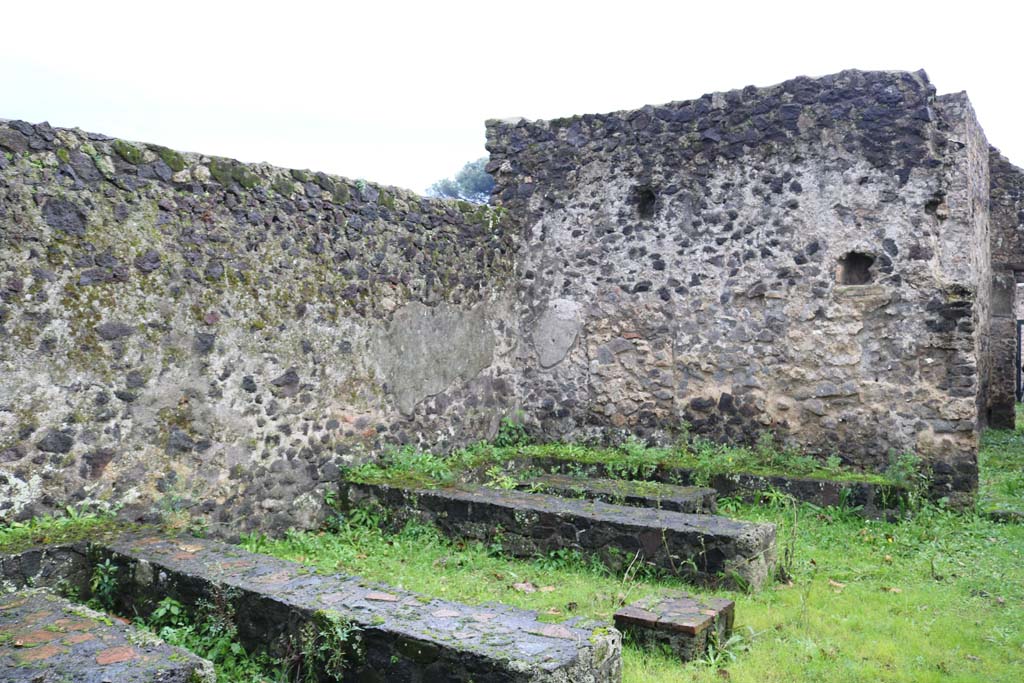 II.8.5 Pompeii. December 2018. 
Three-sided stone benches and tables built against the south wall, looking west. Photo courtesy of Aude Durand.