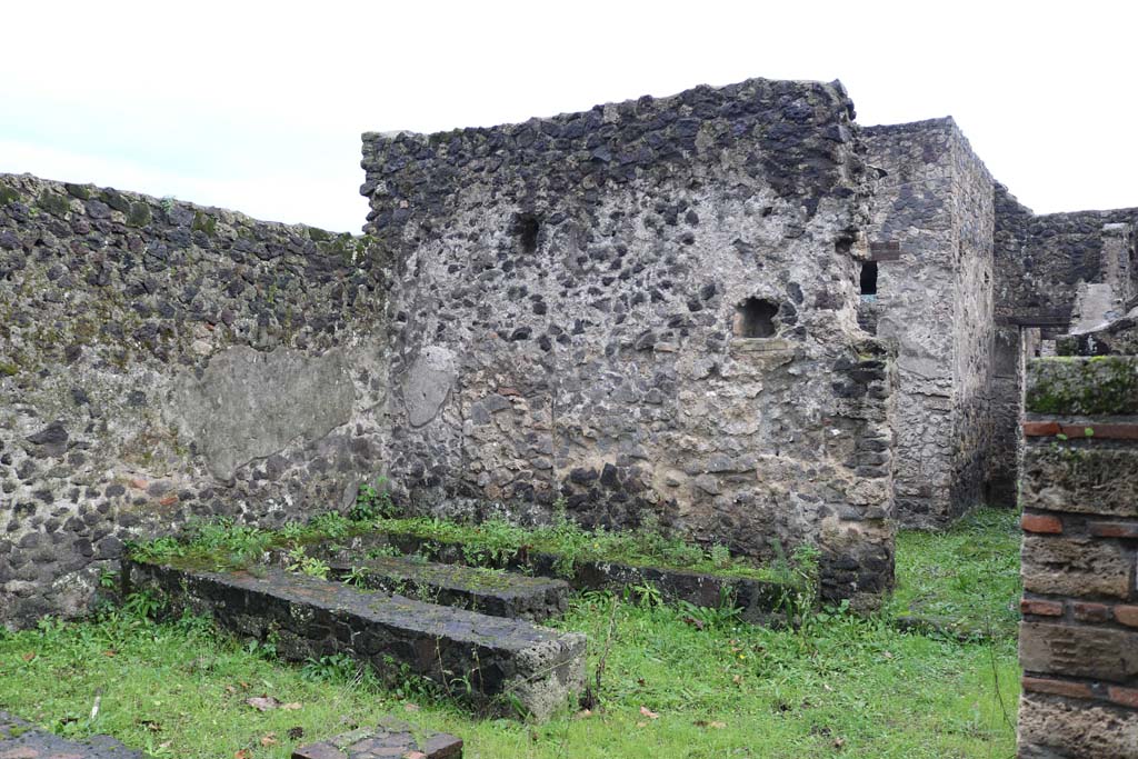 II.8.5 Pompeii. December 2018. 
Looking west towards three-sided stone benches and tables built against the south wall at west end. Photo courtesy of Aude Durand.