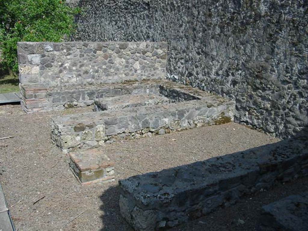 II.8.5 Pompeii. May 2003. Three-sided stone benches and tables built against the south wall, viewed from the west end. Photo courtesy of Nicolas Monteix.
