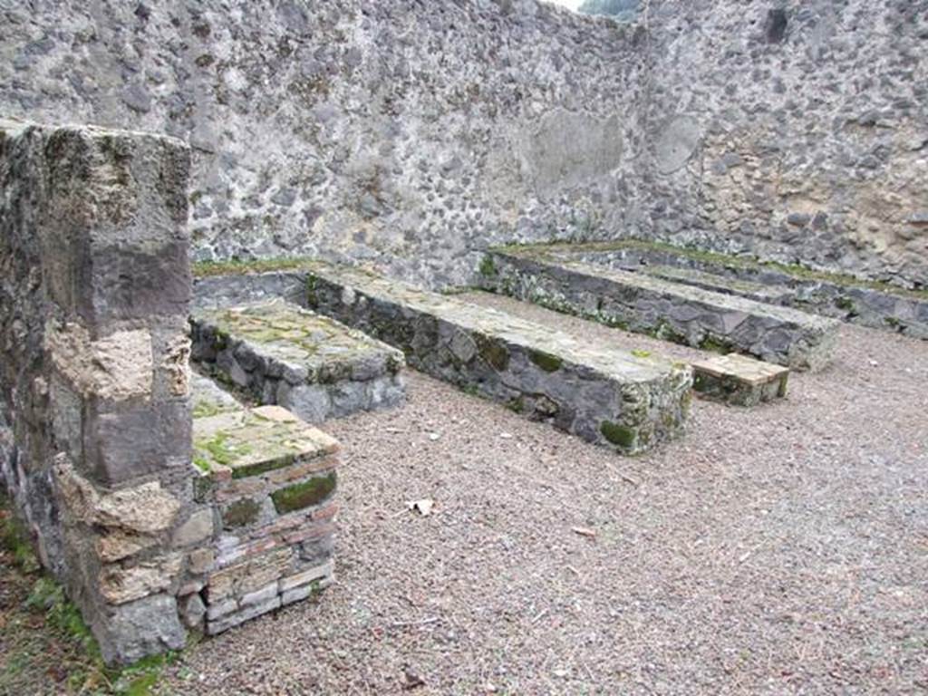 II.8.5 Pompeii. December 2007. Looking west across three-sided stone benches and tables built against the south wall.