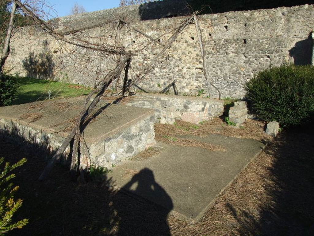 II.8.6 Pompeii. December 2006. Summer triclinium in garden, looking north-east.
According to Wilhelmina, near the triclinium the original excavators had found a human skeleton, two gold finger rings and five gold coins. 
There were also seven medical instruments, two probes and a bronze strigil. 
Found near the lararium was a marble statuette of Hercules, which had once stood in the lararium, so the garden was named the garden of Hercules.
See Jashemski, W.F., 2014. Discovering the Gardens of Pompeii: Memoirs of a Garden Archaeologist, p. 193.