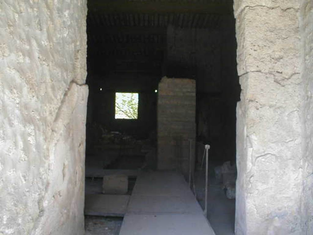 II.9.2 Pompeii. May 2005. Looking east from entrance corridor 1 into room 4. 
In room 4, close to the north wall, two bronze boxes were found containing objects of particular value: gems and work tools, which make the house attributable to a gemmarius or gem cutter.
The stones were yellow jasper, chalcedony-agate, chalcedony-Sardinian, chalcedony-carnelian, chalcedony-carnelian, chalcedony-carnelian, chalcedony-carnelian, chalcedony blue, prasio, quartz stone, rock crystal, and there were three chisels.
See Attività della Soprintendenza: Regio II, Insula 9: Rivista di Studi Pompeiani II, 1988, p. 200, p. 202 note 12.