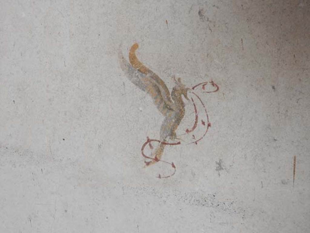 II.9.3, Pompeii. May 2018. Room 11, detail of painted winged creature from east wall in north-east corner.  Photo courtesy of Buzz Ferebee.