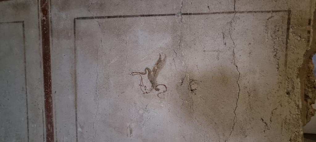II.9.3, Pompeii. December 2023.  
Room 11, detail of painted winged creature from east wall in north-east corner of atrium. Photo courtesy of Miriam Colomer.
