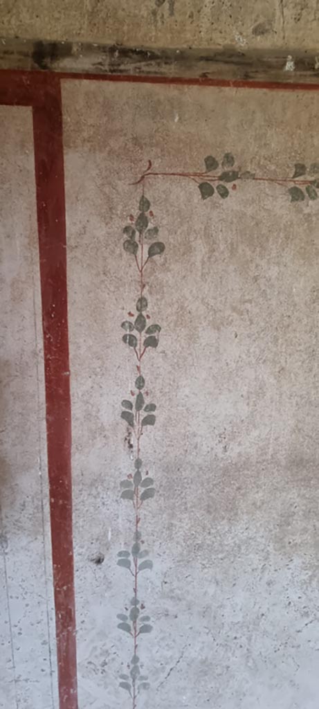II.9.3, Pompeii. December 2023.
Room 14, detail from painted decoration from panel on north wall. 
Photo courtesy of Miriam Colomer.