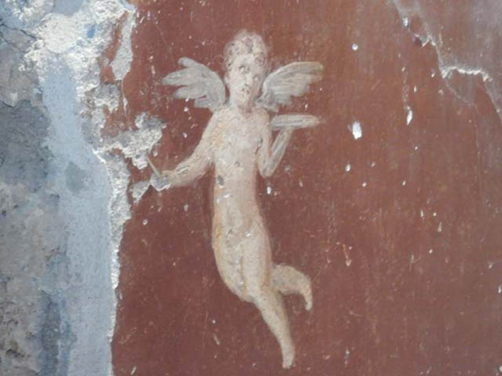 II.9.4, Pompeii. May 2018. Room 6, detail of painted flying figure on red panel of south wall of cubiculum.
Photo courtesy of Buzz Ferebee.