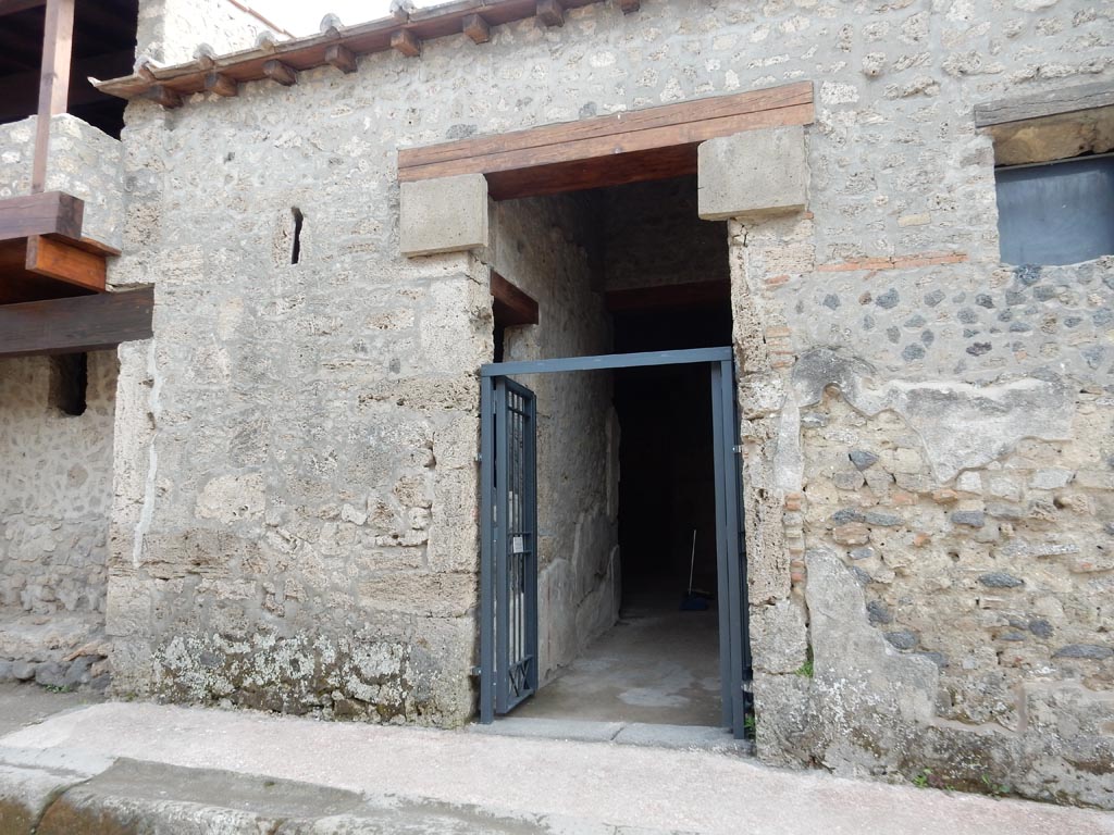 II.9.4 Pompeii. May 2018. Looking towards entrance doorway on east side of Via di Nocera.
This house is linked to the dwelling at II.9.3, and because the closed doorway there is still blocked by a plaster-cast of the door at the time of the eruption, the entrance to both houses is here at II.9.4 but see also II.9.3 for its rooms.  Photo courtesy of Buzz Ferebee.