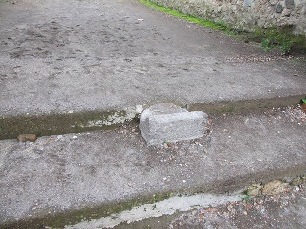 Base of portal between II.1.9 and II.9.6, in centre of steps to Via di Castricio from Via di Nocera. It was originally used for crowd control to the Amphitheatre.
