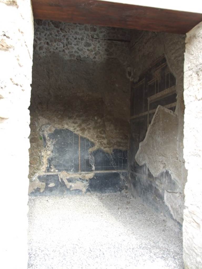 III.2.1 Pompeii. March 2009. 
Doorway to room 7, from room 6, looking east along south wall towards south-east corner.
The south wall must have been affected by the 1943 bombing.