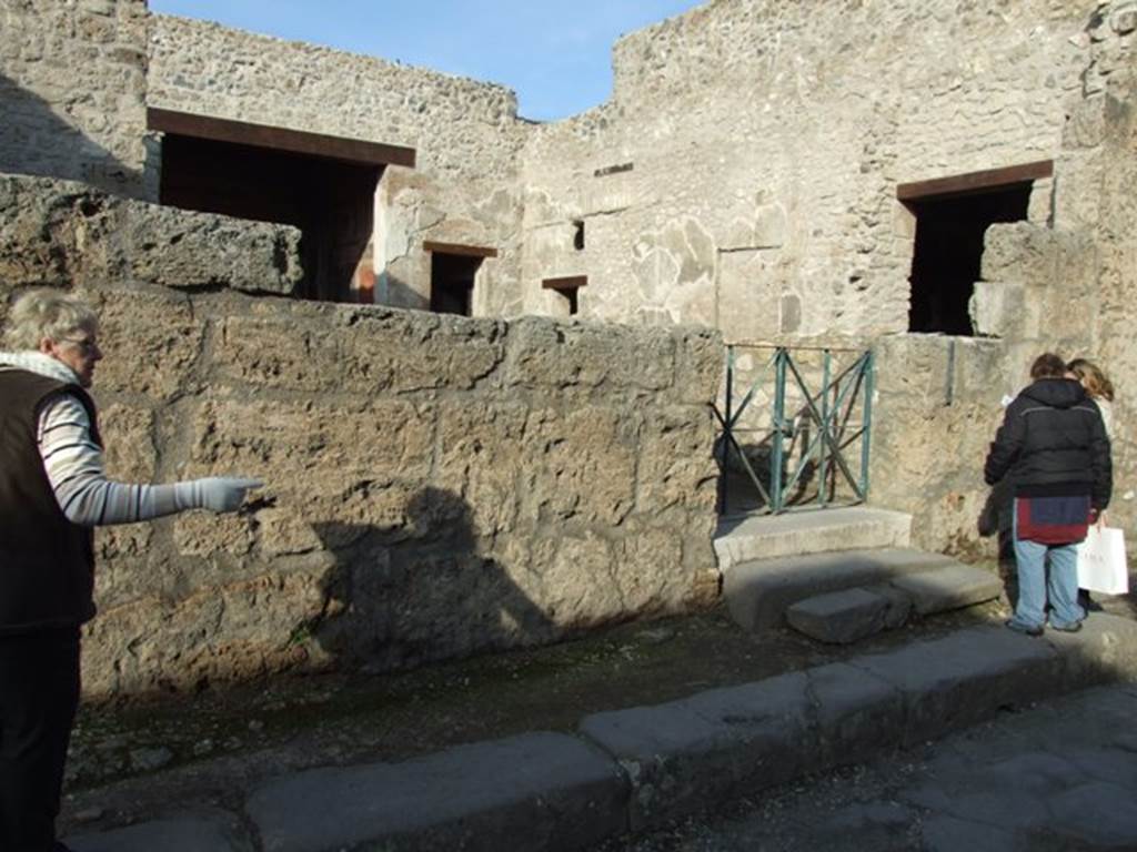 III.2.1 Pompeii. December 2007. Front wall on west side of entrance on Via dell’Abbondanza.
The wall on this side of the entrance was destroyed when a bomb landed in the atrium on 19th September 1943.
All of the painted graffiti, electoral recommendations and an announcement of games in the amphitheatre were lost.
The wall on the east side was devastated by another bomb landing to the south-east of the house in the Via dell’Abbondanza.
A small portion of the writings on the east side were saved, restored and can still be read today. 
See Garcia y Garcia, L., 2006. Danni di guerra a Pompei. Rome: L’Erma di Bretschneider. (p.51-53, incl. photos of damage).